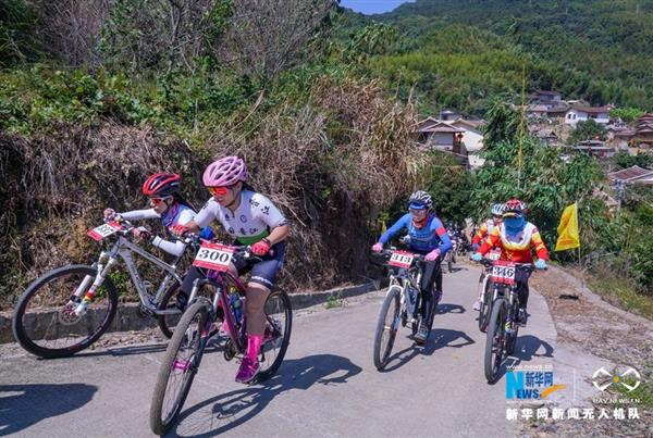 10月20日,女子组比赛中,女骑手在爬坡路段上冲刺.新华网 肖和勇 摄